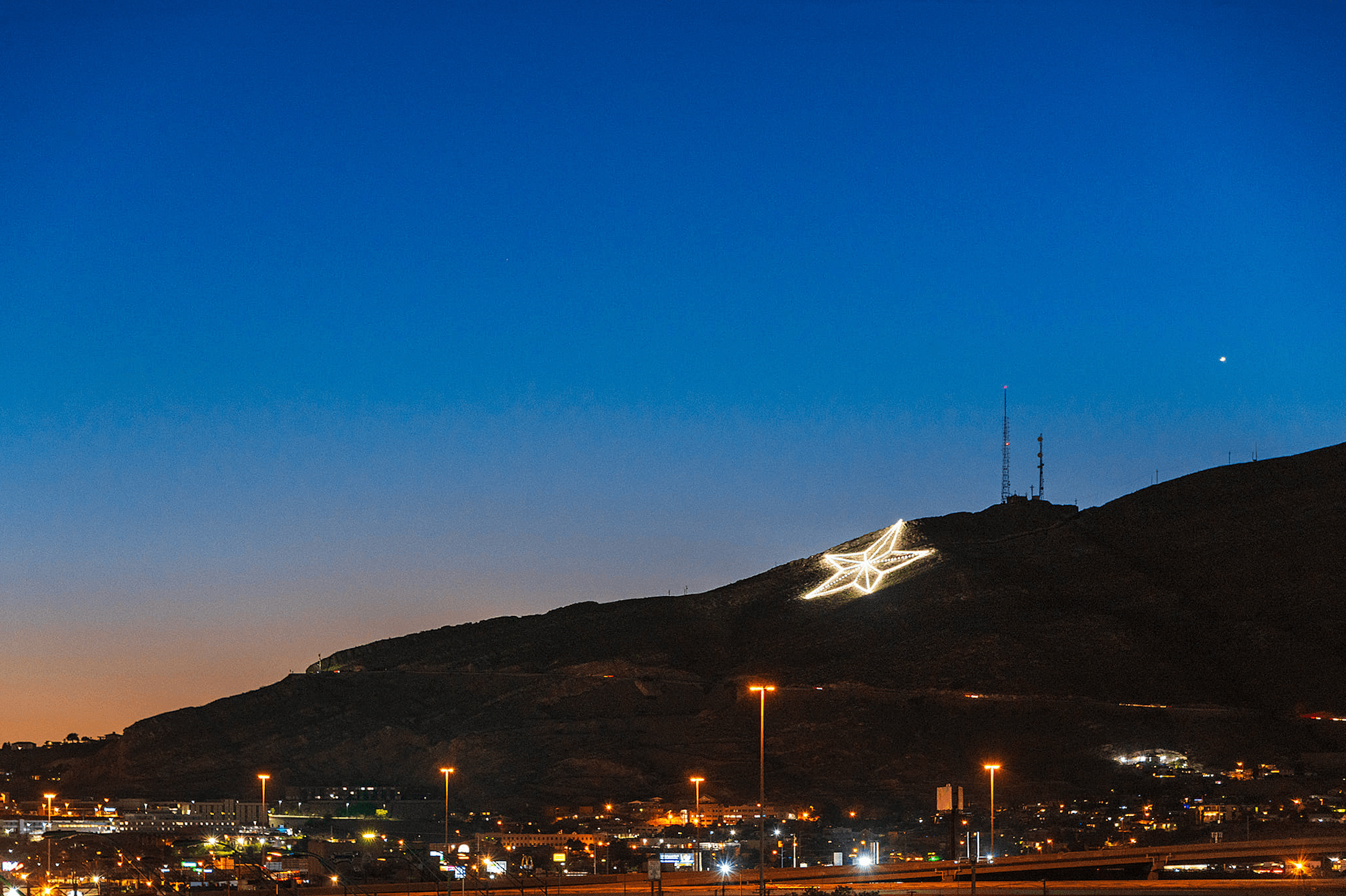 El Paso city lights at night with mountains in the distance